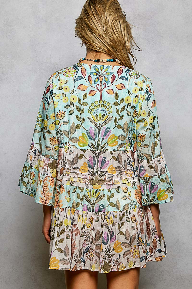 Woman wearing a floral dress with a gray background