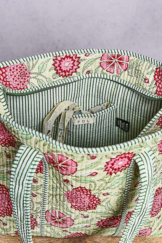 Floral-patterned bag with striped lining on a gray background