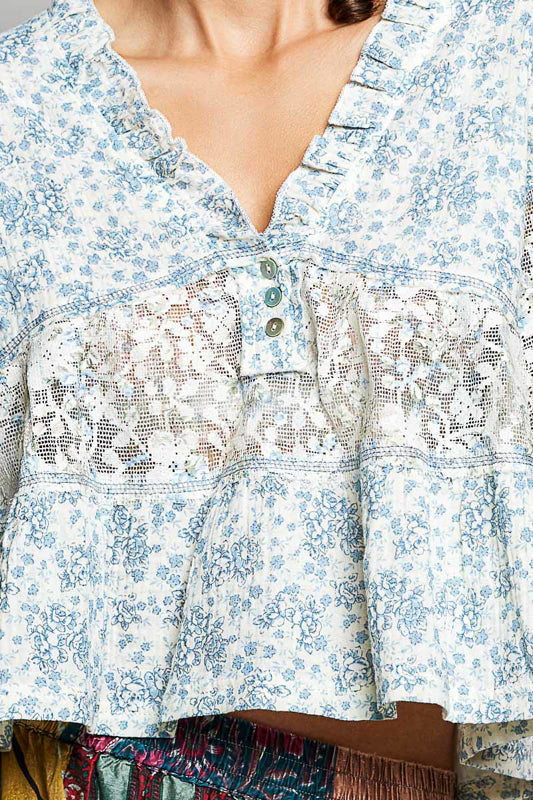 Close-up of a floral blouse with lace details