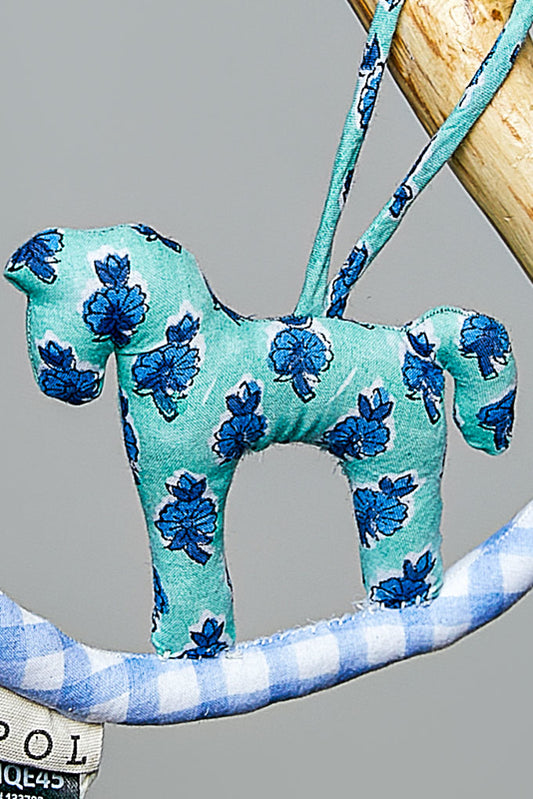 Fabric horse ornament with blue floral pattern on a gray background