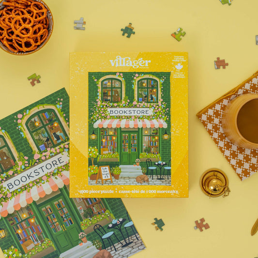 Villager Bookstore puzzle box on a yellow background with puzzle pieces scattered around