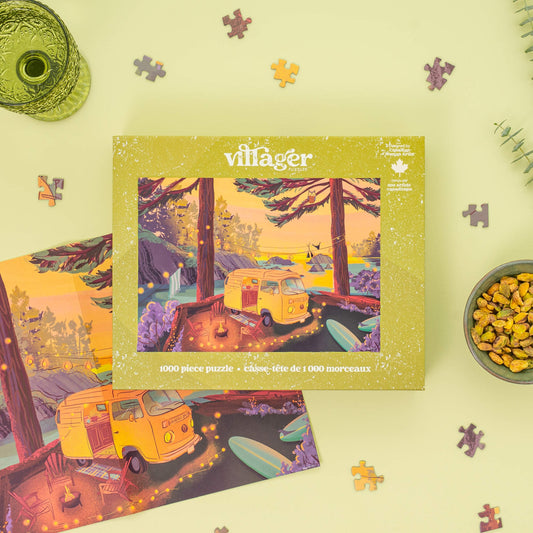 Villager puzzle box with a camper van design on a light green background with scattered puzzle pieces.