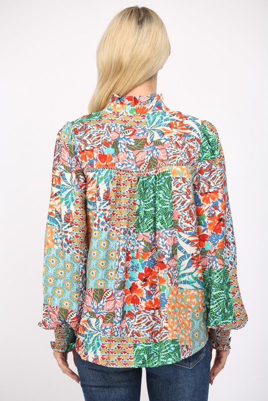 Women wearing a patterned blouse and blue jeans on a white background.