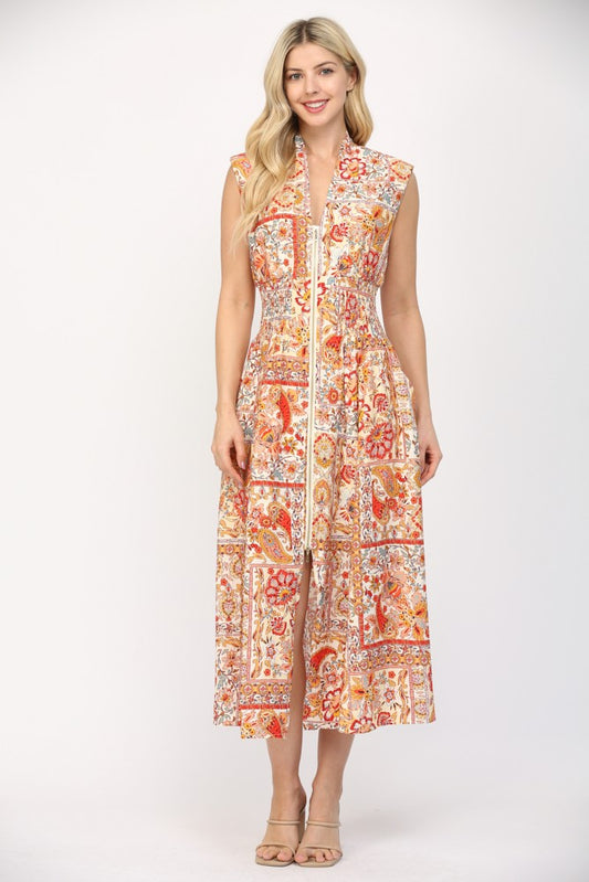 Women wearing a printed orange and cream summer dress.