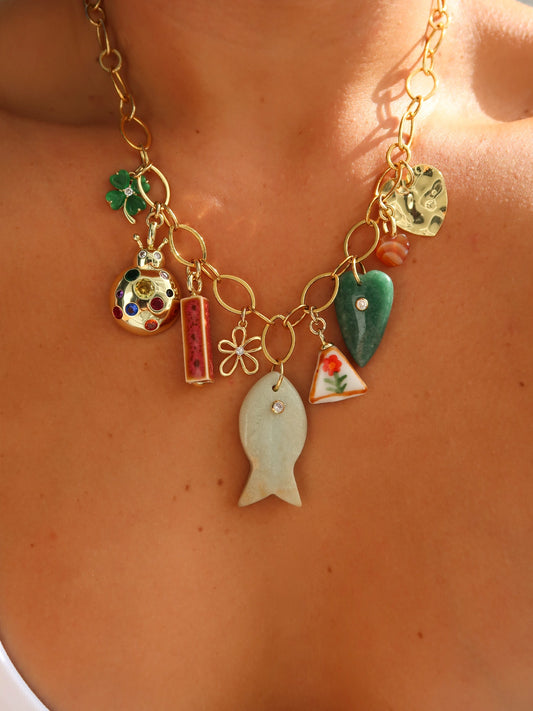 Necklace with various charms on a person's neck