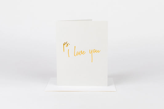 White card with 'ps. I love you' text in gold on a white background