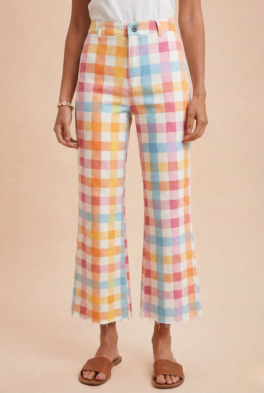 Person wearing colorful plaid pants on a beige background