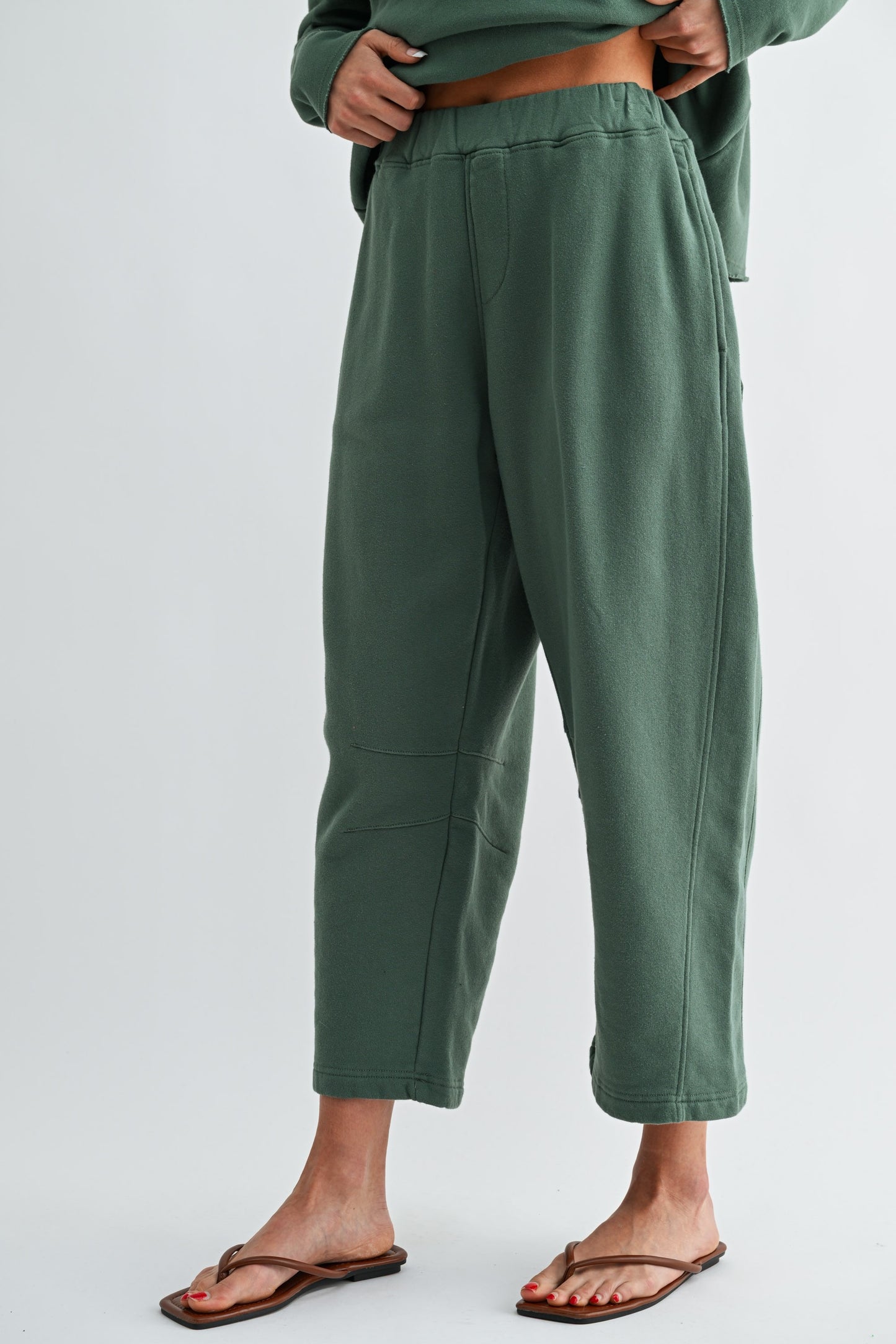 Green pants worn by a person on a light gray background