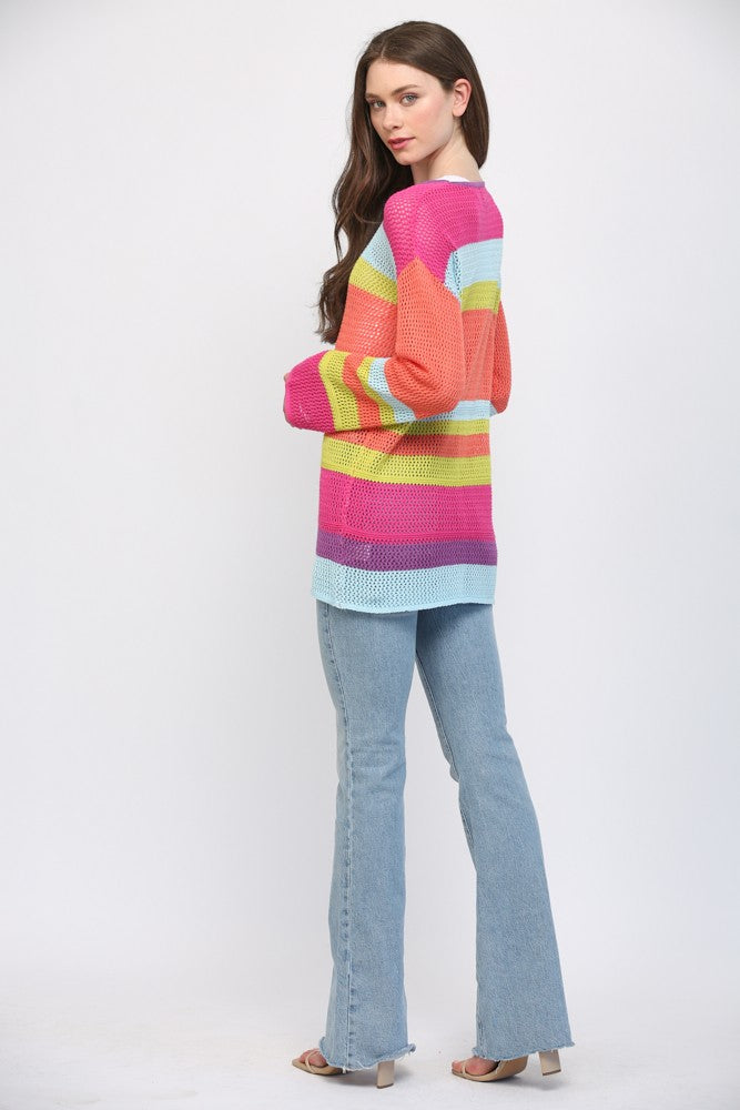 Women wearing a striped bright colour sweater and blue jeans.
