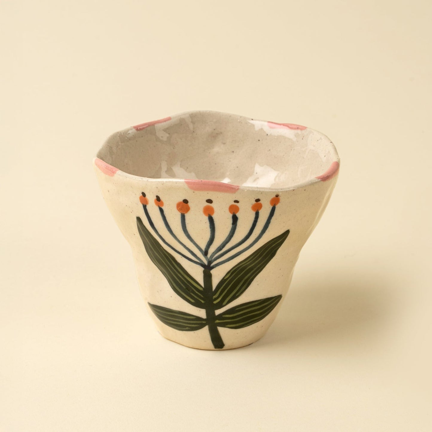 Ceramic cup with floral design on a beige background