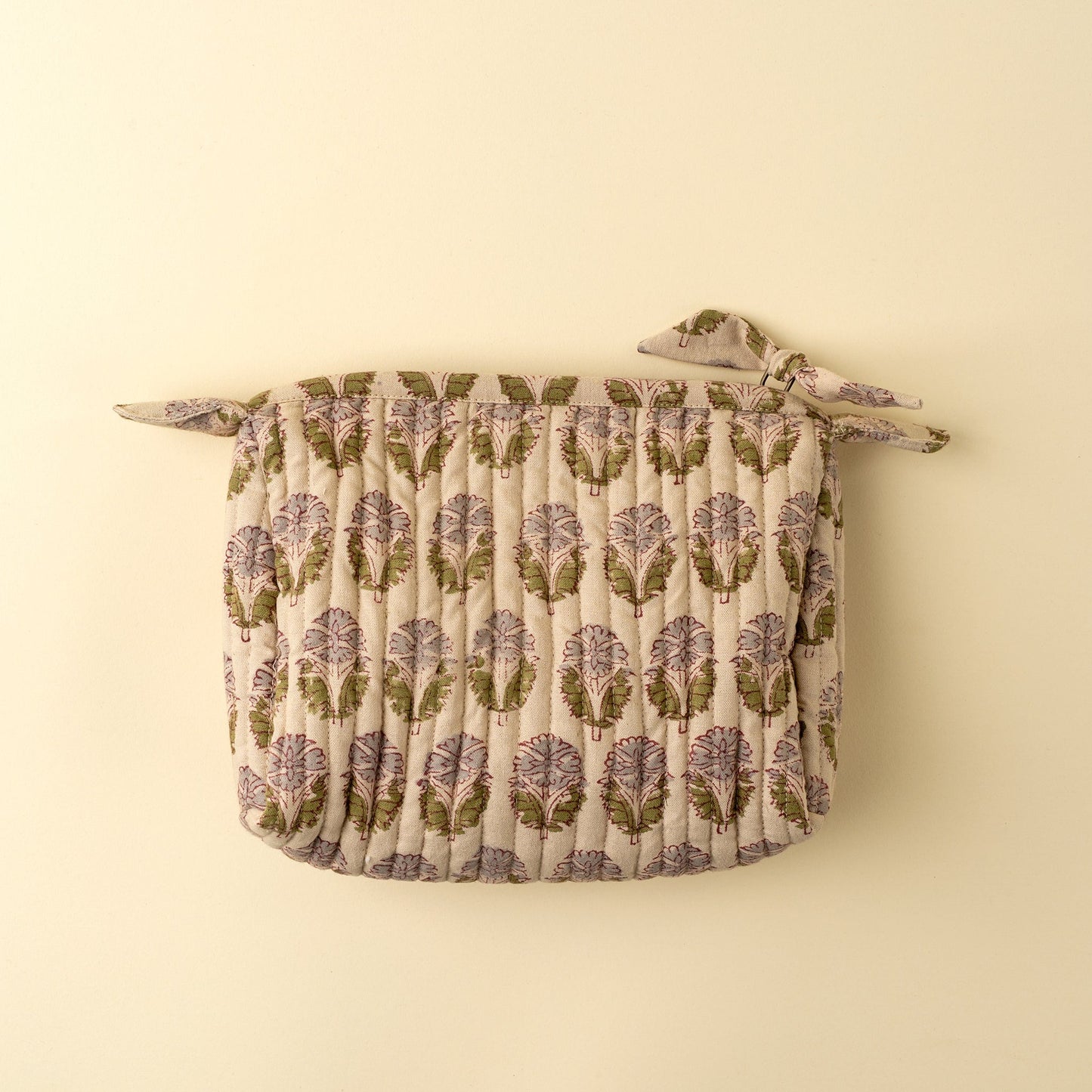 Floral patterned pot holder on a beige background