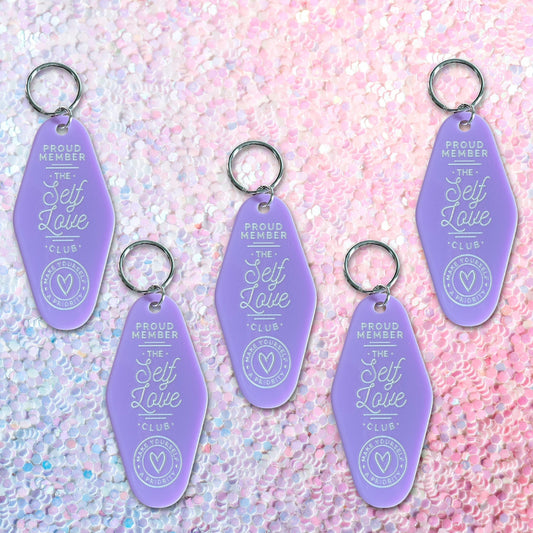 a hotel key tag shaped keychain with the phrase proud member of the self love club