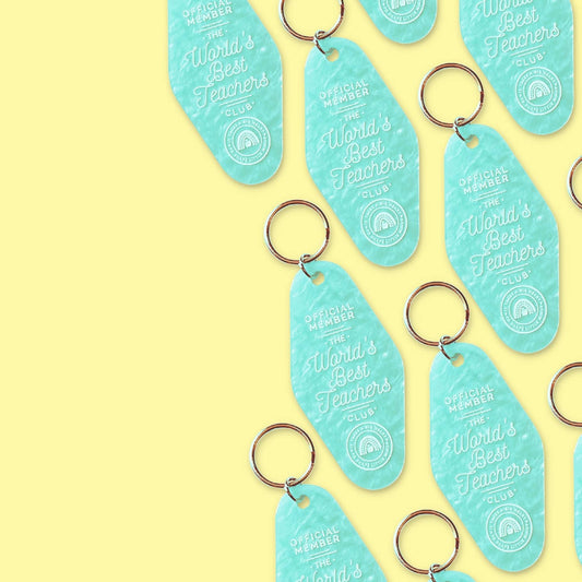 a hotel key tag shaped keychain with the phrase worlds best teacher