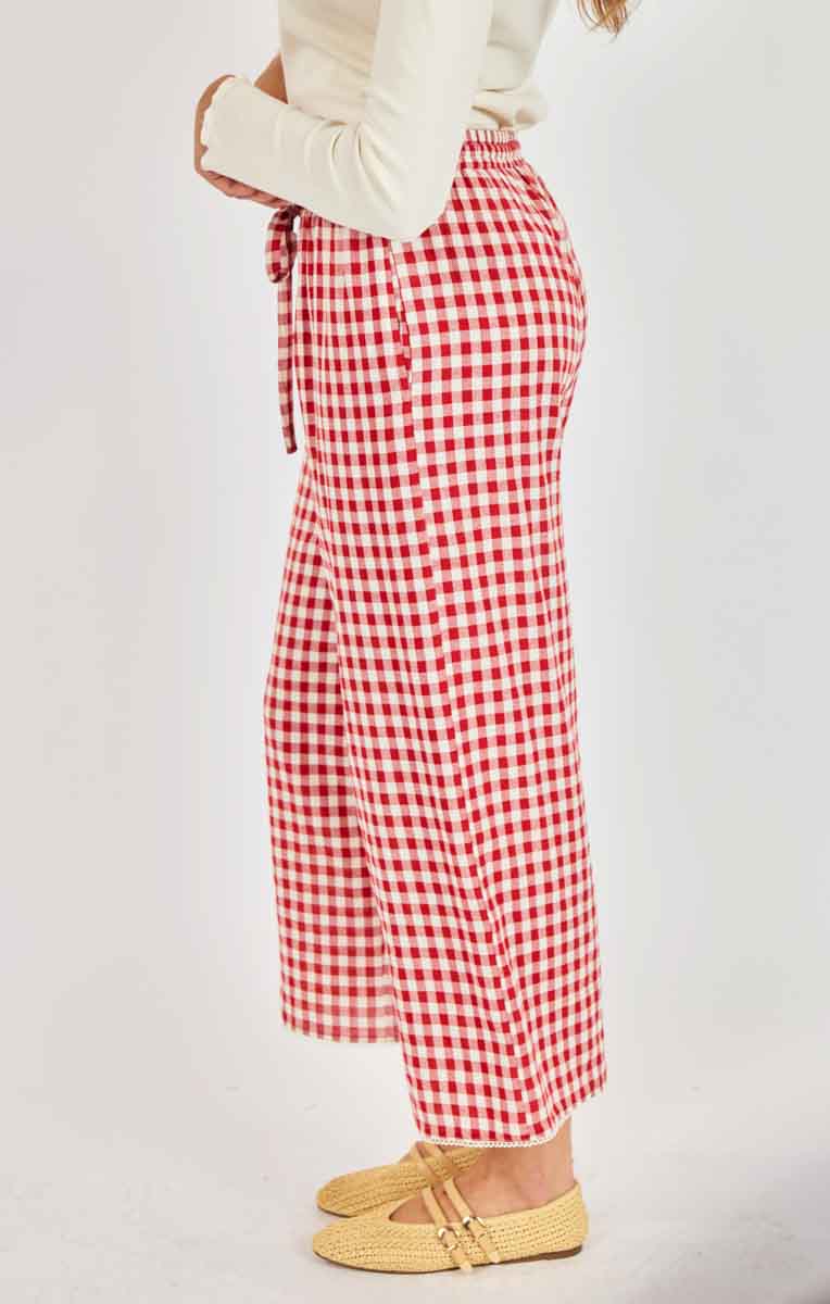 Red and white checkered pants worn by a person on a plain background