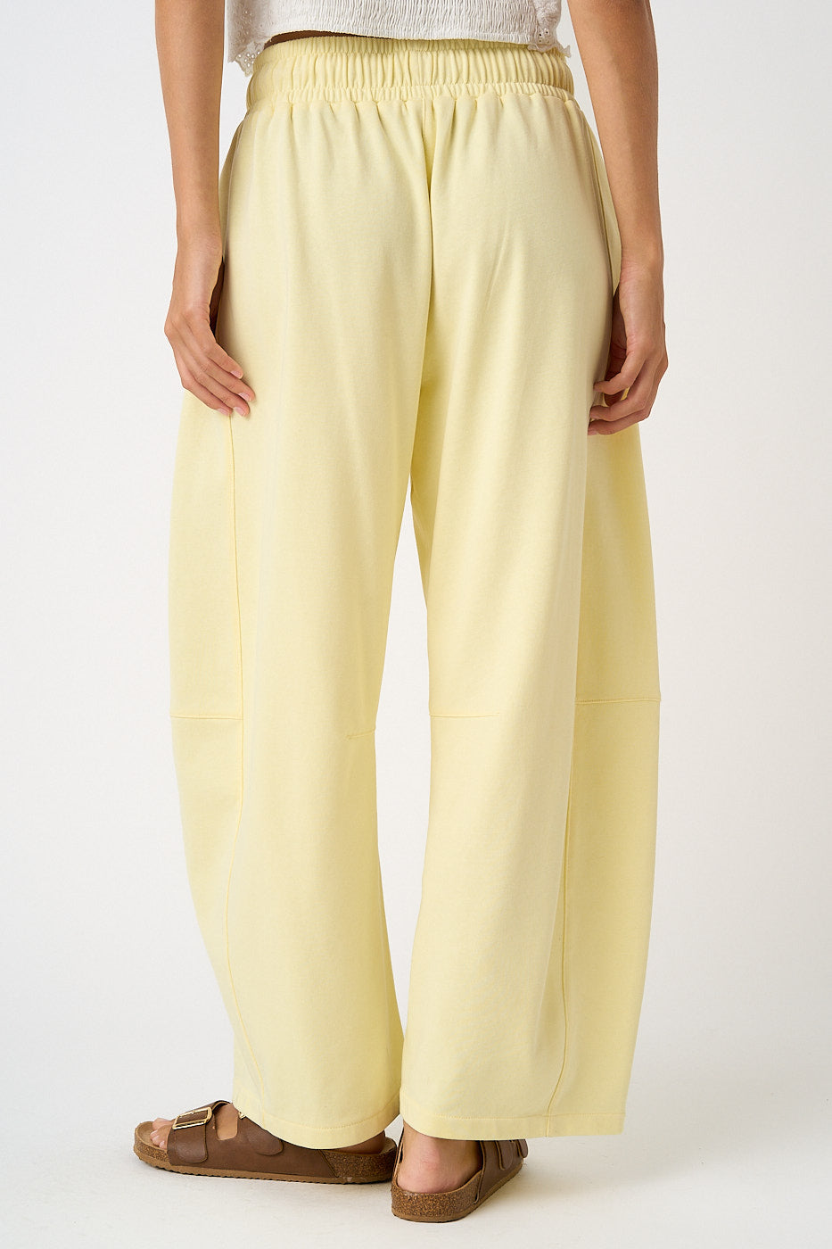 Light yellow pants worn by a person on a white background