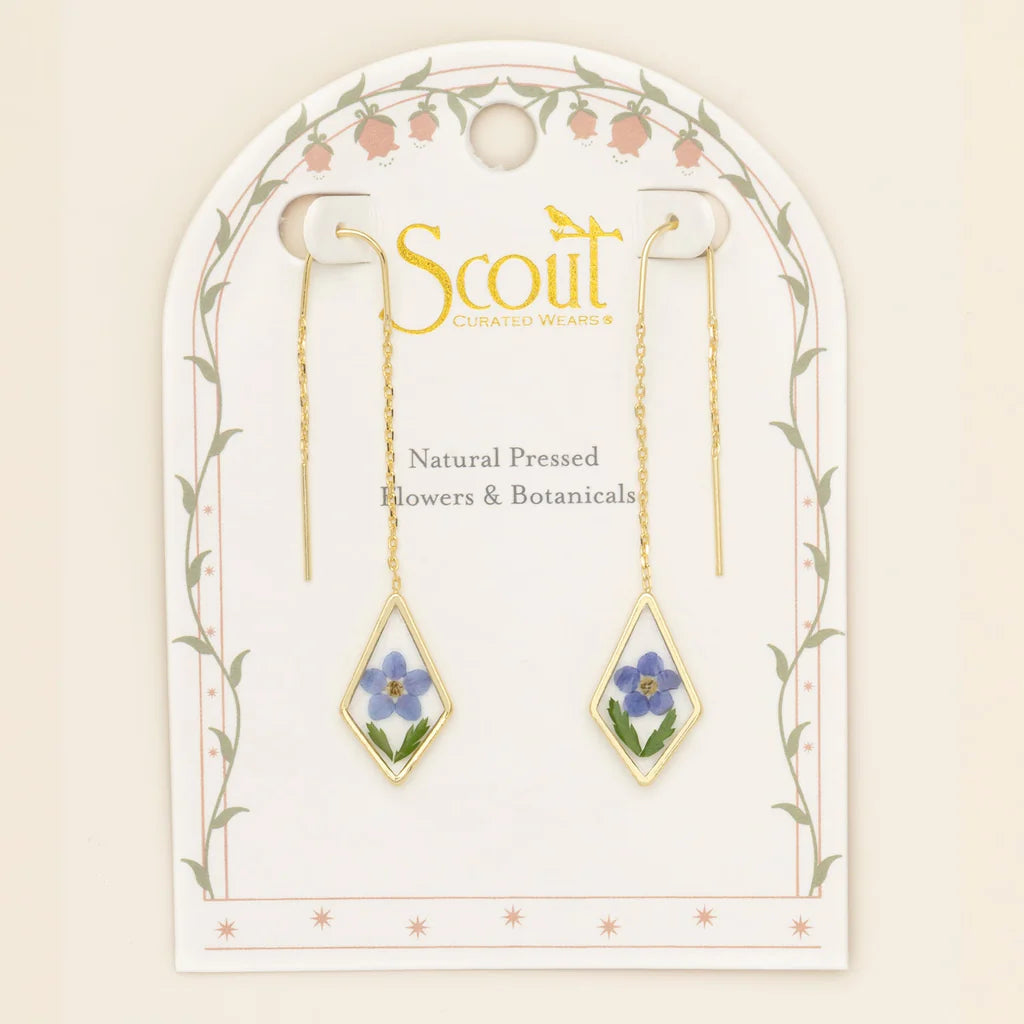 Gold earrings with natural pressed flowers on a Scout branded card.