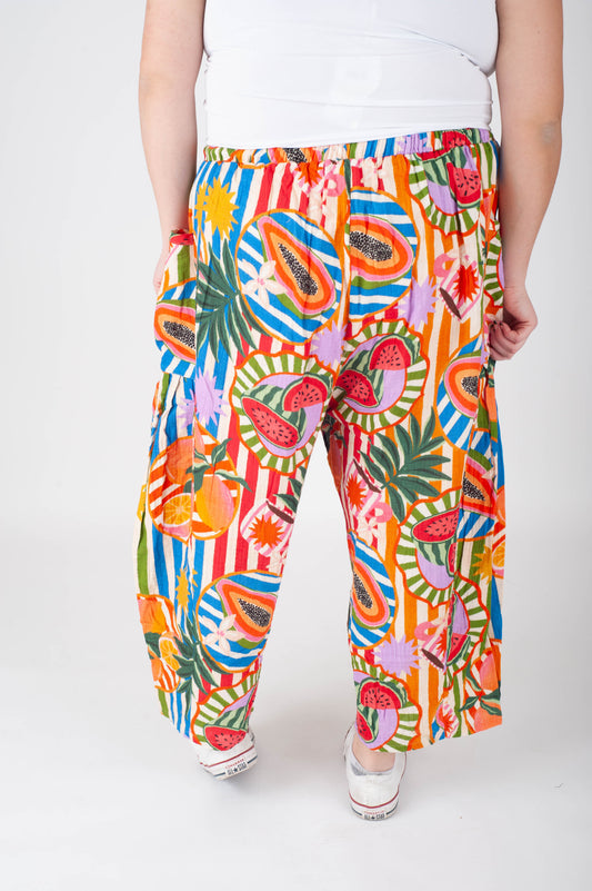 Colorful patterned pants worn by a person on a white background
