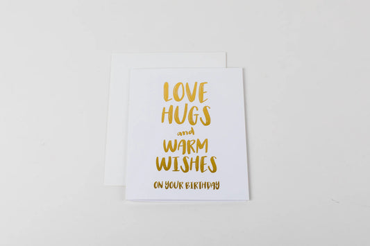 Greeting card with 'Love hugs and warm wishes on your birthday' text on a white background