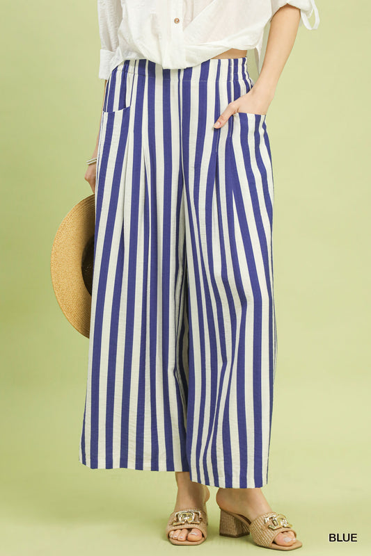 Person wearing blue and white striped pants on a green background