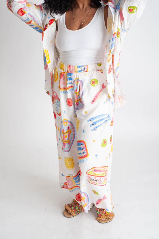 Person wearing a colorful outfit with cartoon character design on a plain background