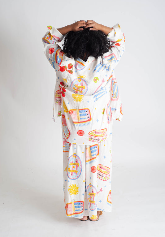 Person wearing a colorful onesie with cartoon designs on a white background