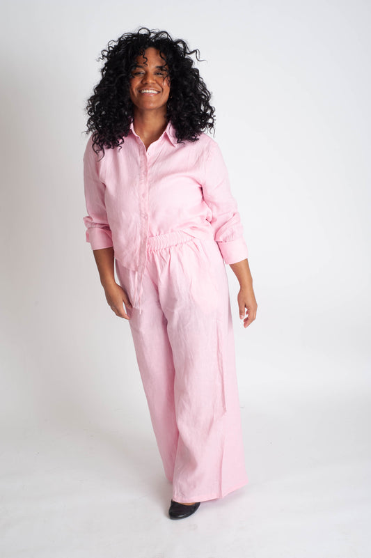 Person wearing a pink matching set on a white background