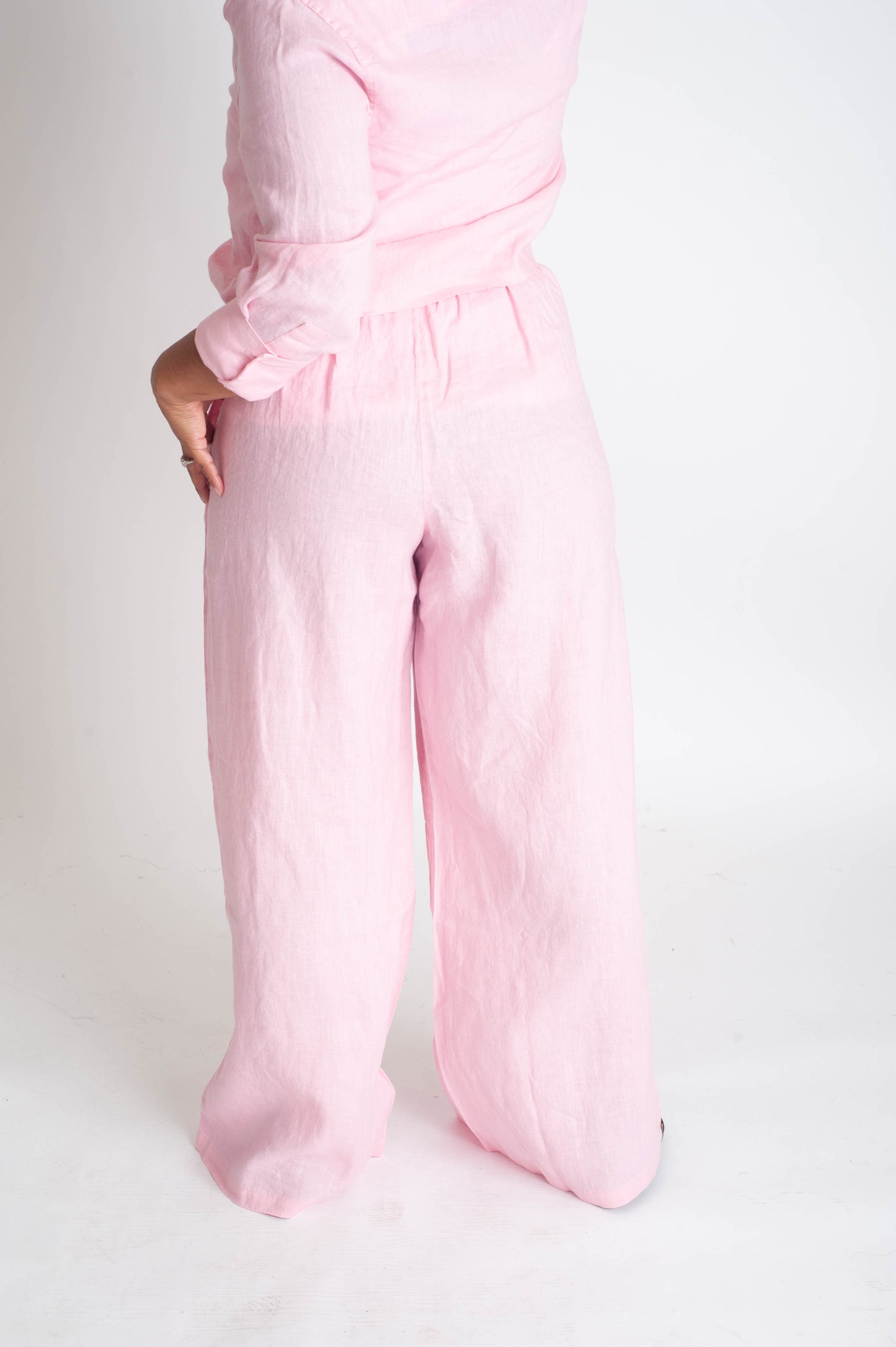 Person wearing pink pants on a white background