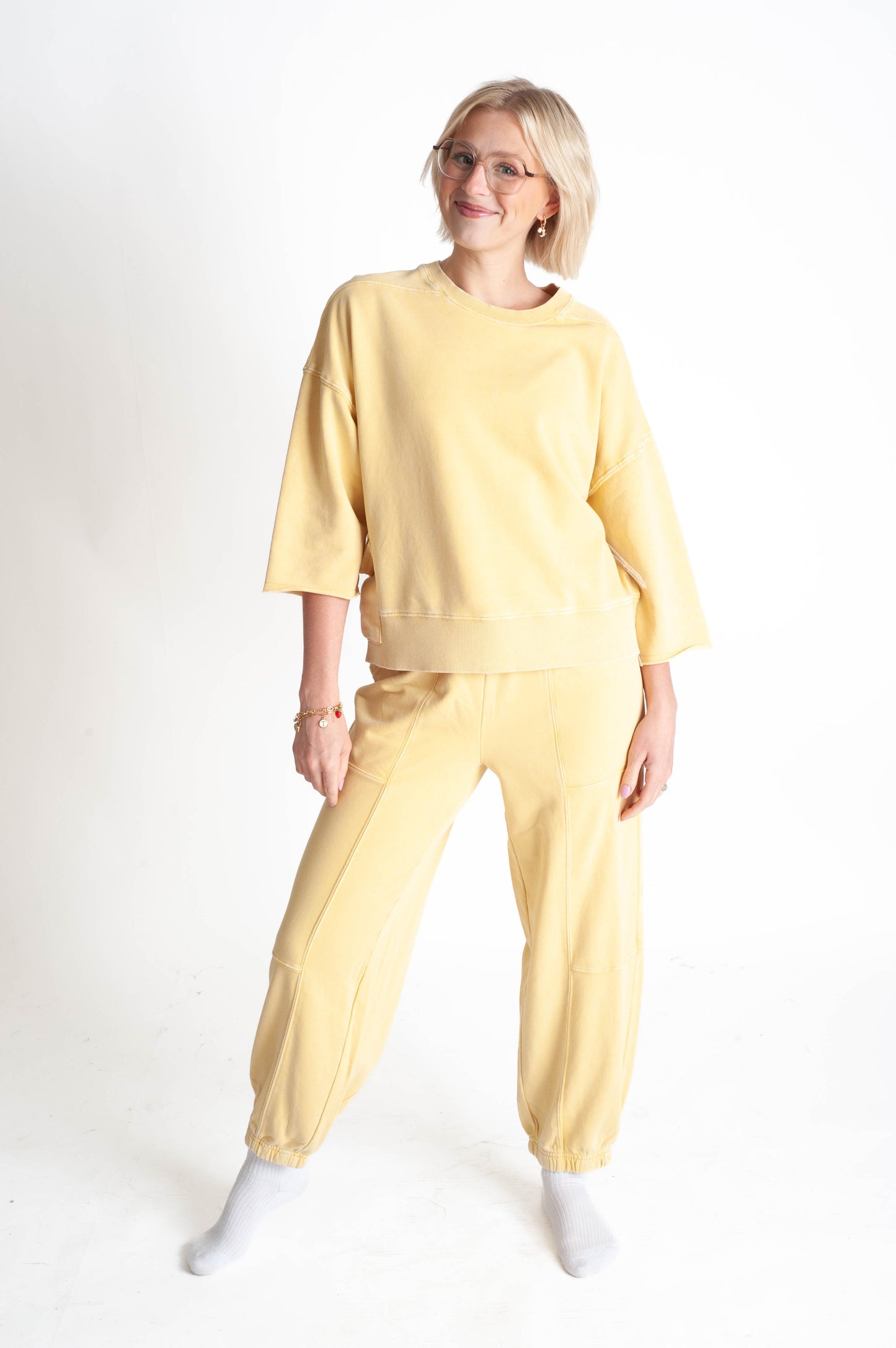Person wearing a yellow outfit on a white background