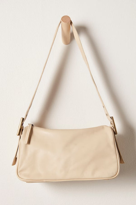 Beige handbag with a strap on a white background