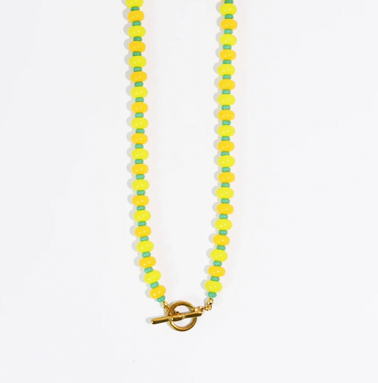 A Yellow & Green beaded necklace against a white background.