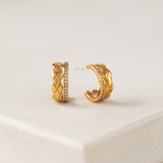 A pair of gold-plated double hoop earrings with cubic zirconia stones, displayed against a neutral background.