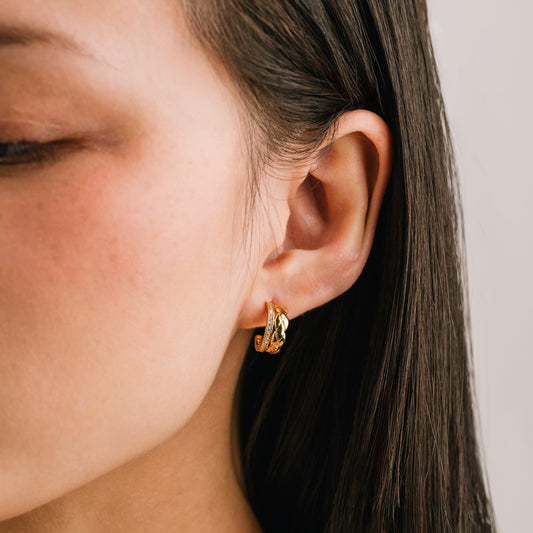 a women wearing gold hoop earrings