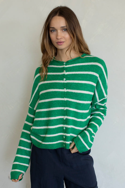 Women wearing a green and white striped cardigan.