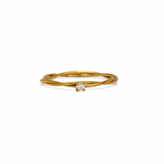 Gold ring with a diamond on a white background