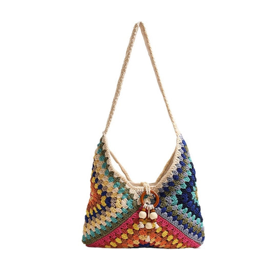 Colorful crocheted handbag with a decorative charm on a white background