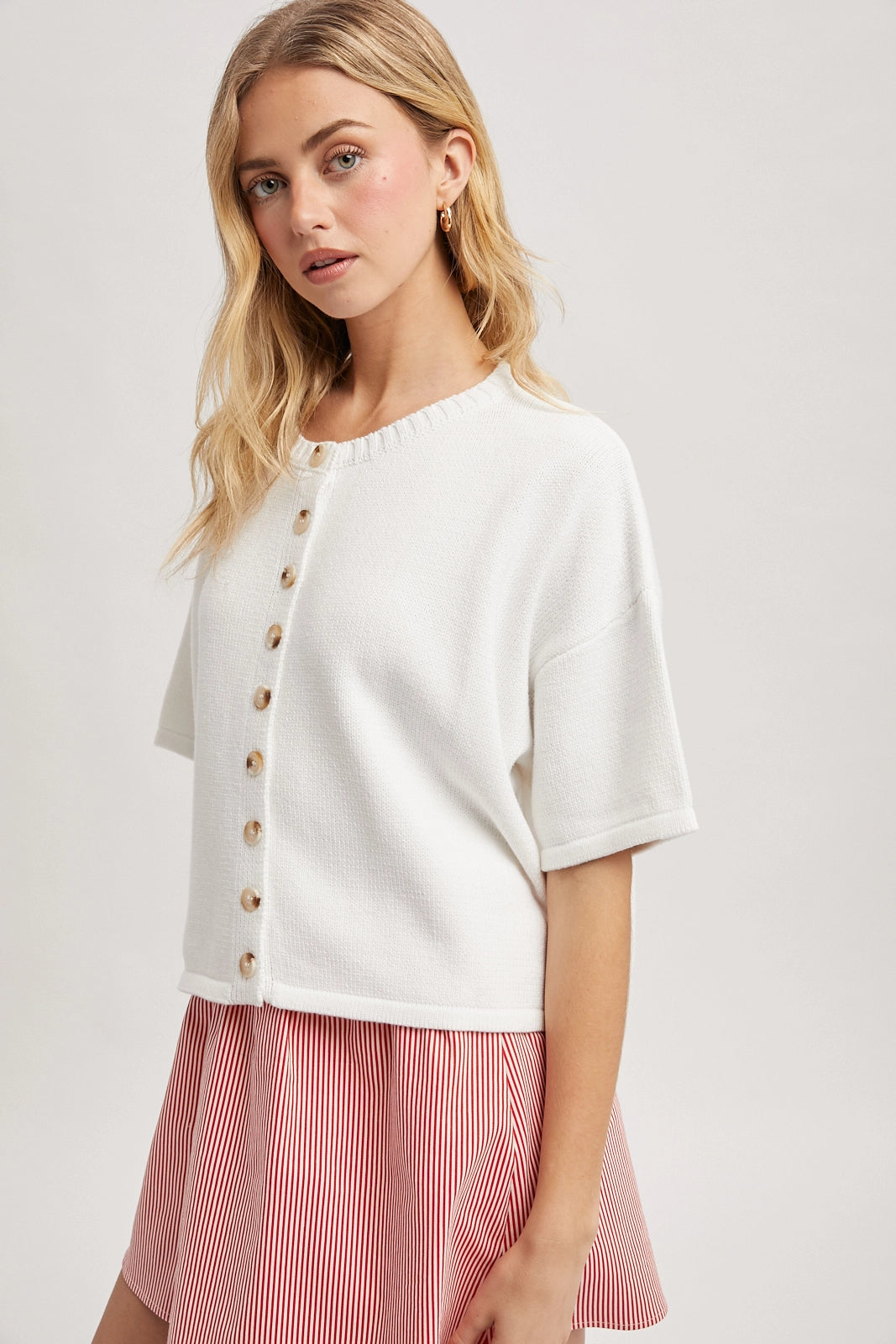 Women wearing a short sleeve button up cardi.