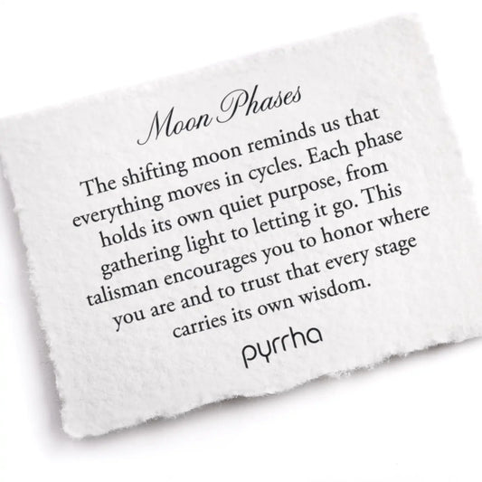 White stone with engraved text about moon phases and pyrrha branding