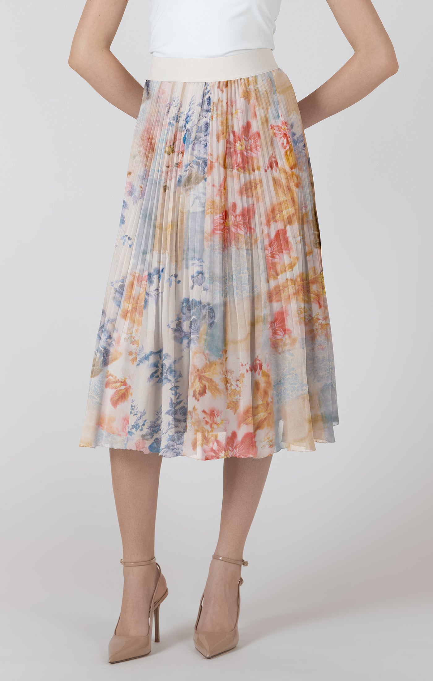 Woman wearing a colorful floral skirt on a white background