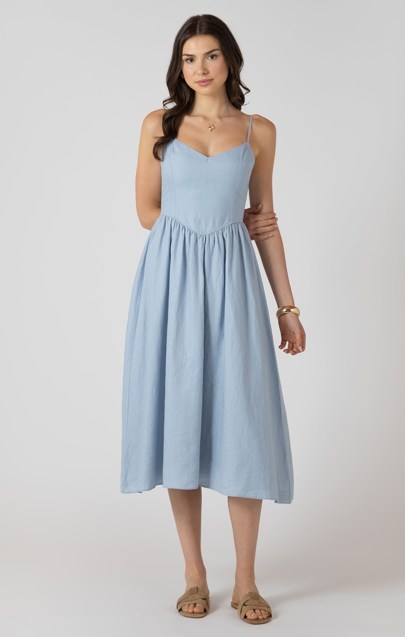 Woman wearing a light blue dress on a white background