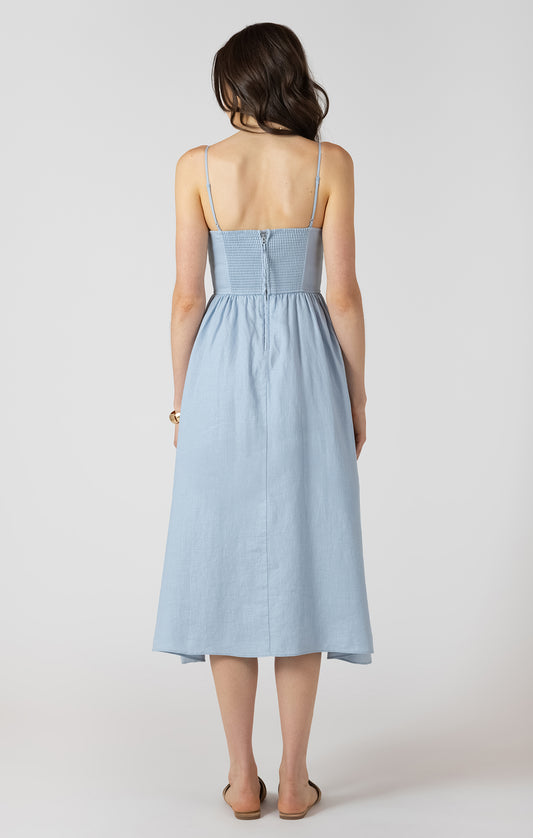 Woman wearing a light blue dress against a white background