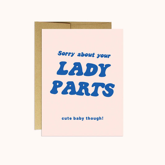 A greeting card with blue writing on pink paper.