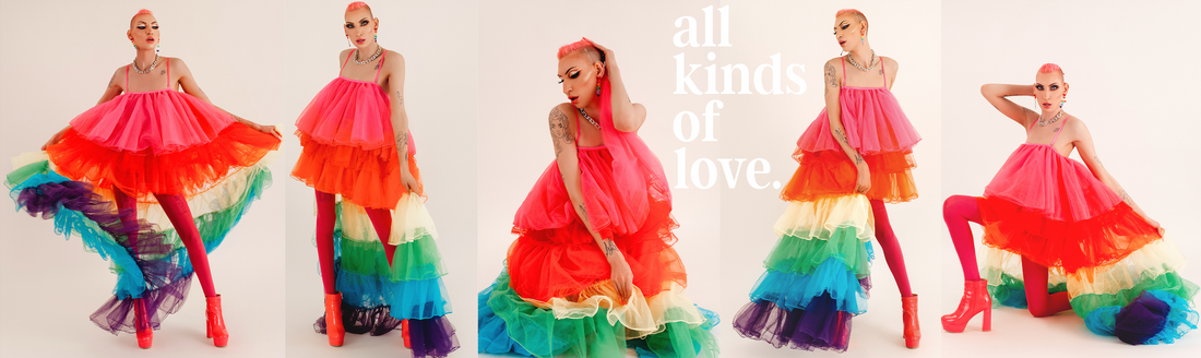 a drag queen in a rainbow outfit celebrating their self lvoe
