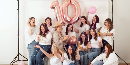 A group of women with confetti celebrating a 10 year anniversary