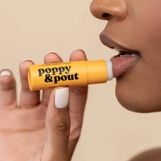 women applying poppy& pout lip balm