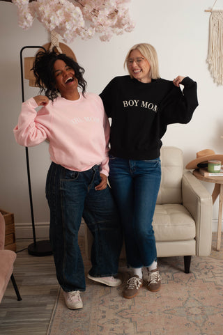 two women wearing mom themed graphic sweaters