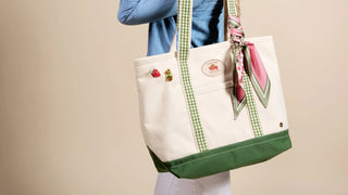 women carrying a tote bag with a scarf and buttons on it. 