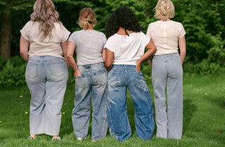 4 women wearing blue jeans and white tops