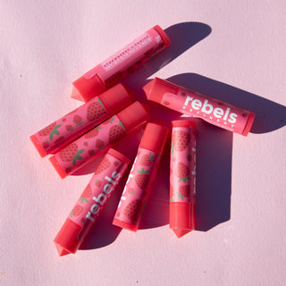 Lip Balm flat lay against a pink background