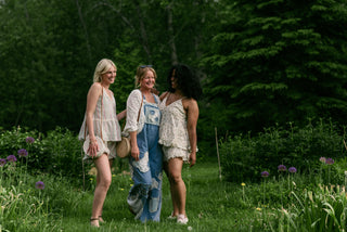 Women wearing boho inspired outfits in a garden.