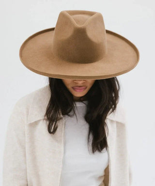 women wearing a brown fedora on a white background.
